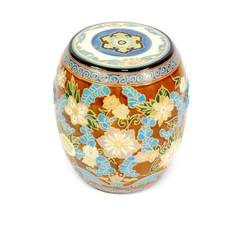 A Chinese pottery garden seat of barrel form, decorated in enamel with flowers, 40cm H.