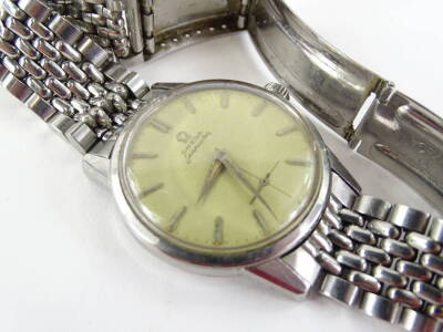 A 1960 Omega Seamaster gentleman's wristwatch, in steel case with champagne coloured dial and rectangular batons, the back decorated with a sea horse seamaster logo, with Omega strap, sold with original guarantee from model number 17044044, purchased in B - 8