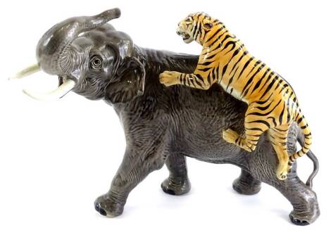 A Beswick ceramic model of an elephant, being attacked by a tiger, 30cm H.