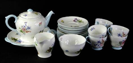 A Shelley Wild Flowers pattern part tea service, to include teapot cover, two sandwich plates, side plates, milk jug, sugar bowl, and cups and saucers.