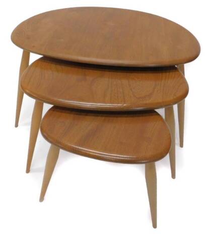 A nest of three Ercol elm and beech pebble tables, each on turned legs, the largest 55cm W.