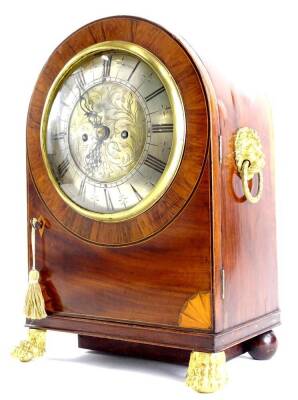 A 19thC and later mahogany and rosewood mantel clock, the arched case with a gilt lion mask handles, the silver dial with Roman numerals, on paw and ball feet, brass movement, associated, 44cm H.