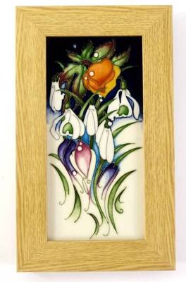 A Moorcroft porcelain rectangular Snowtime pattern plaque, decorated with snow drops, etc., in oak frame, impressed marks and hand written and signed signature of artist to underside, 27cm x 16cm.