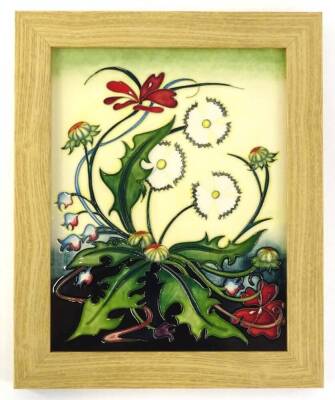 A Moorcroft pottery Meadow pattern rectangular plaque, decorated with dandelion and other plants and weeds, in oak frame, impressed and hand written makers signature to reverse, 32cm x 26cm overall.