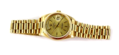 A Rolex Oyster Perpetual Day-Date 18ct gold gentleman's wristwatch, with gilt coloured dial having applied stick batons surrounded by a linked minute track, interspersed by Roman numerals. Having two apertures for day and date, the latter with trademark c - 2