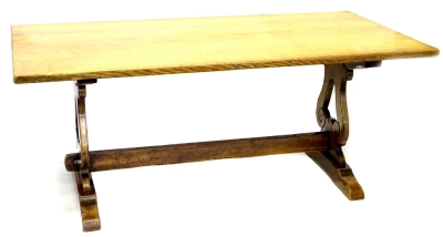 An oak rectangular refectory table, with a plain rectangular top, on pierced lyre shaped supports with shaped ends and rectangular stretcher, 74cm H, the top 90cm x 183cm.