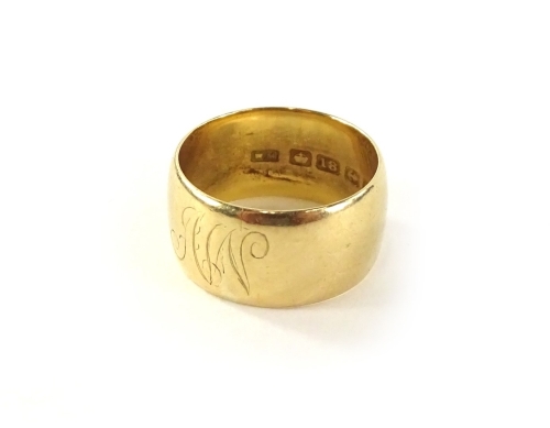 An 18ct gold wedding band, Birmingham assay, bearing initials A W, 7.1g all in.