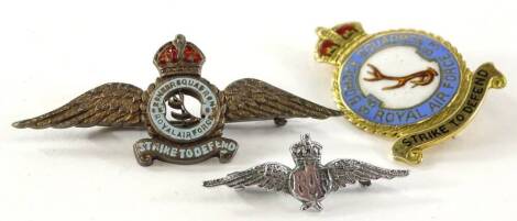 Three RAF badges, comprising a silver enamel 'Strike to Defend' brooch, a 9ct gold and enamel Bomber Squadron 83 'Strike to Defend' pin, 7.4g, and a silver plated RAF wings badge. (3)