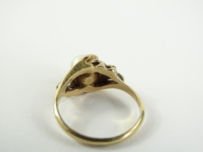 A pearl dress ring, set with central pearl, flanked by two CZ set shoulders, in white metal setting, the pearl crudely set with glue, on a yellow metal band, marked but unclea,r possibly 9ct, ring size N½, 3.3g all in. - 2