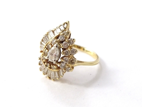 A diamond cluster ring, with sixty five round brilliant cut diamonds of varying size, between 2mm to 3.2mm diameter, claw set with white spiral effect cluster head, with split twist shoulders, yellow metal, tests as 14K, total estimated carat weight 2.18c