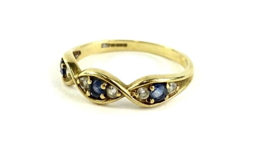 A 9ct gold dress ring, set with three sections each set with single sapphire, flanked by two diamonds, ring size P, 1.9g all in.