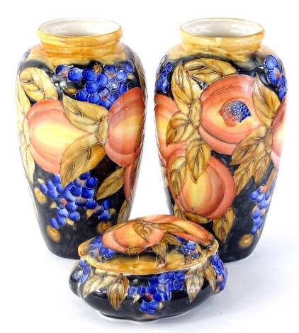 A pair of modern Moorcroft type vases, each decorated with peaches, grapes and leaves, titled Florian ware to underside, probably continental and a similar boxed and cover, the vases 98cm H.