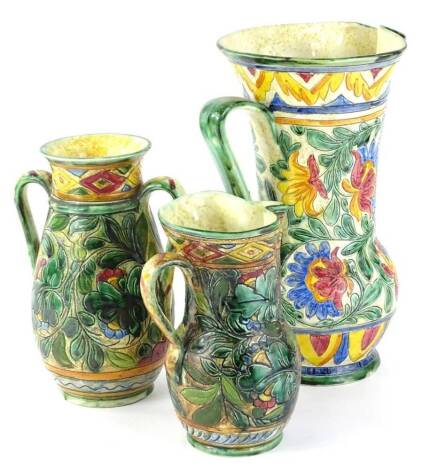 Three items of Beswick sgraffito ware, to include a large ewer, a smaller example and a two handled vases, each decorated in Italian style with leaves flowers with geometric bands, the largest 31cm H.