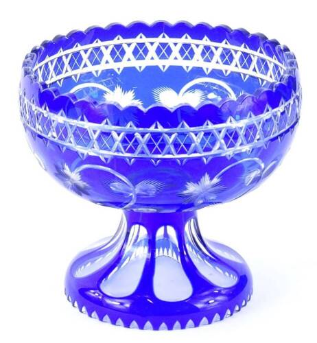 A blue flash glass centrepiece, engraved with flowers etc., within a geometric border, 19cm H, 23cm Dia.