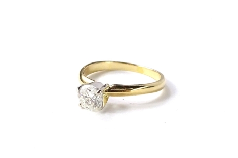 A modern diamond solitaire ring, with round brilliant cut diamond approx 0.59cts, in four claw platinum raised setting, on a plain yellow metal band, stamped 14k, ring size K, 2g all in, in Goldsmiths box, and numbered to band 7512872.