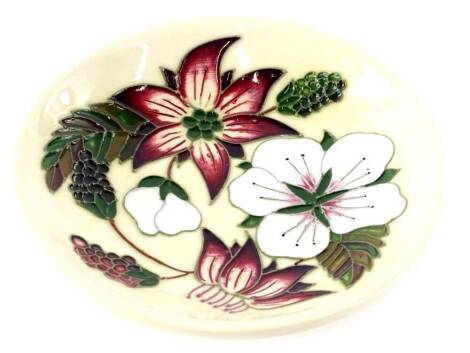 A Moorcroft circular Bramble Revisited pattern dish or pin tray, decorated with pink and white flowers, impressed marks to underside.