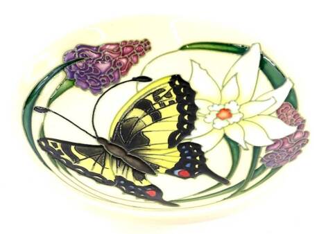 A Moorcroft pottery Butterfly Collection pin tray or small dish, decorated with a peacock butterfly, flowers, etc., impressed marks to underside, 12cm dia, boxed.