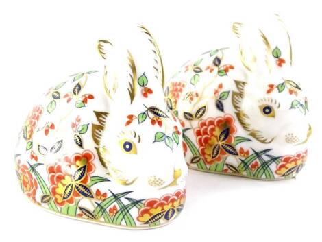 A pair of Royal Crown Derby Collectors Guild Meadow Rabbit paperweights, each with a gold button.