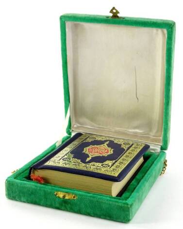 A presentation copy of an Islamic book, with gilt tooled binding in a velvet lined case with inscription to hinged lid.