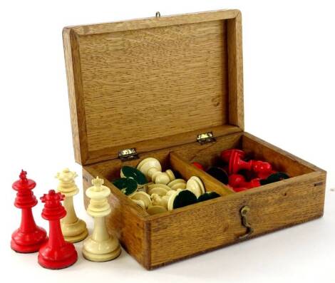 An early 20thC bone chess set, part stained red, the King 6cm H.