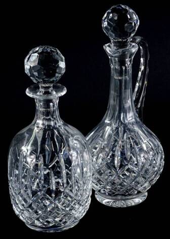 A cut glass claret jug and stopper, and a decanter and stopper (2).