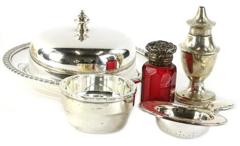 A collection of items, to include a silver mounted ruby tinted scent bottle and cover, a silver salt pot, a circular silver plated butter dish and a plated tea strainer and stand.