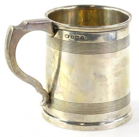 A George V silver christening mug, of cylindrical form, decorated with reeded bands, Birmingham 1932, 6½oz, 9cm H.