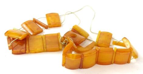 An amber necklace, with rectangular cut beads, 1.6cm x 1cm, on plain string necklace, (AF), 14.8g all in.