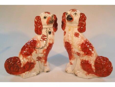 A matched pair of 19thC Staffordshire pottery seated spaniels