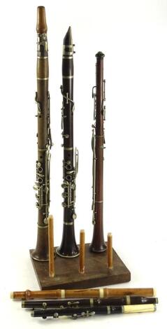 Two early 20thC rosewood clarinets, and another part clarinet etc., the largest 70cm L.