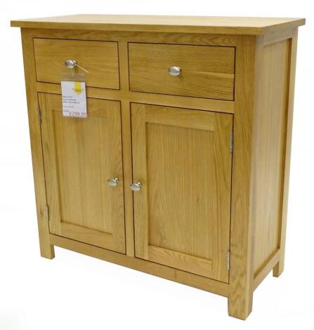 An ex shop display natural oak small sideboard, with two drawers and two panelled doors, 80cm H, 80cm W, 34cm D, retail price was £499.99 reduced to £299.99.