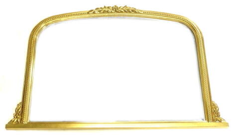 A Victorian style gilt gesso overmantel mirror, with an arched top, 102cm W.