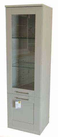 An ex shop display Abingdon Stone display cabinet, with single glaze door and a panel door, 179cm H, 54cm W, retail price was £920.00 reduced to £460.00.