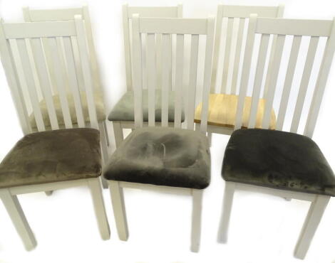 A collection of six ex shop display dining chairs, each painted in pale grey, to include, five with similar fabric seats and a chair with a solid oak seat.