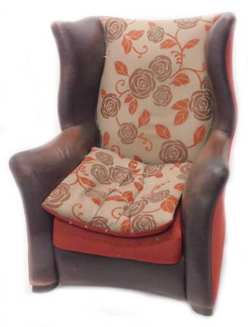 A modern leather wingback armchair, upholstered in floral fabric.