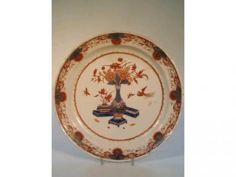 A 19thC Imari dish, painted in underglaze blue, iron re and gilt to the