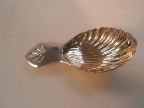 A modern silver caddy spoon