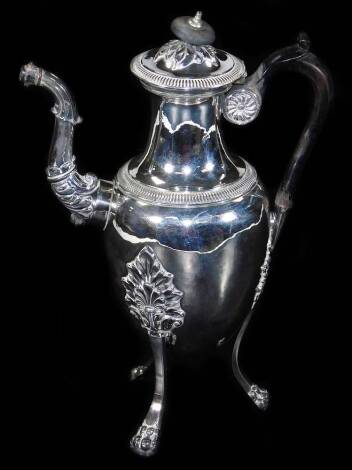 An early 19thC French Parisian coffee pot, with inverted neck, compressed domed lid, bulbous body, triple acanthus capped hairy paw feet, on compressed orbs, with ebonised angular handle and elaborate repoussé decorated spout, with Paris .950 and Grosse G