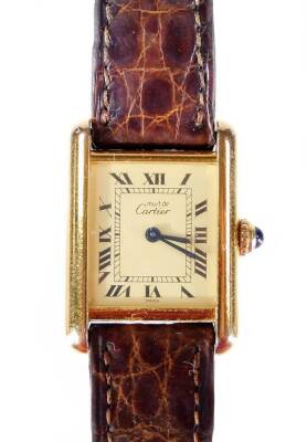 A Must-de-Cartier ladies wristwatch, with rectangular watch head, and cabochon sapphire set winder, marked to the case Cartier Paris Vermeil, Tank Quartz, Argent, numbered 130033 and 5057001, in gold coloured casing, marked 925, with import marks, on brow