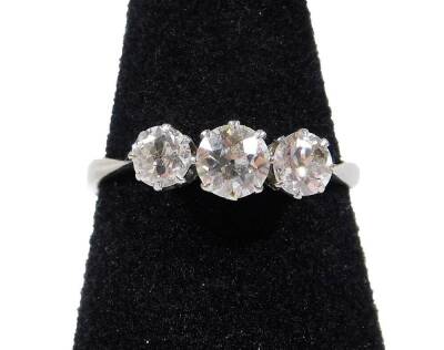 Top Bid £500 - A three stone diamond ring, with three round brilliant cut diamonds, the central stone measuring 4.4mm x 4.4mm x 2.6mm, approx 0.30cts, flanked by two smaller diamonds, each measuring 3.4mm x 3.4mm x 2.4mm, approx 0.20cts each, total estima