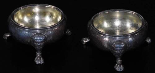 A pair of George III silver open cauldron salts, each of circular form on triple mask headed lion paw feet, initialled AH, other marks badly worn, 8cm W, 5½oz. (2)