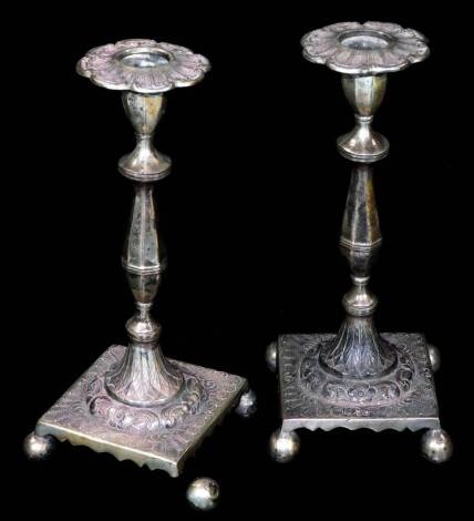 A pair of late 19thC candlesticks, each with floral dish holders on inverted stems, circular feet and squat platform bases, terminating in orb feet, marked Prata ALG, white metal, 22cm H, 23oz. (2, AF)