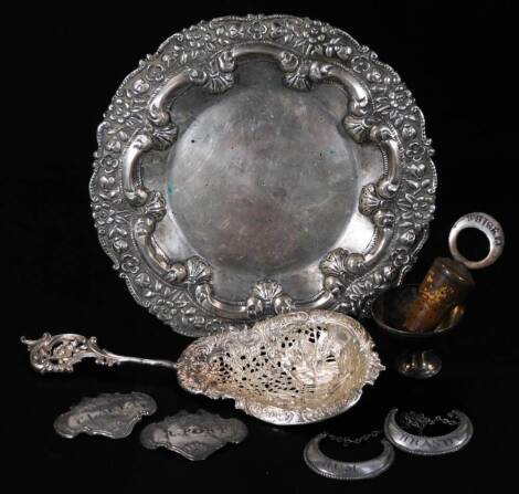 A continental dish, of shaped floral outline, repoussé decorated with a flowerhead and scroll border, with plain centre, unmarked white metal, possibly Dutch, 19cm W, an elaborate Dutch serving spoon, partially pierced with an entwined scroll handle, vari