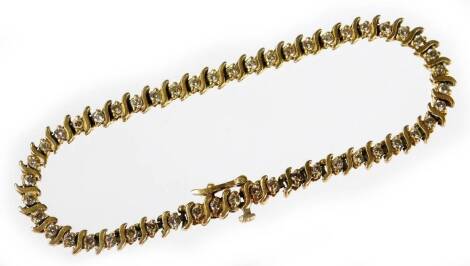 A diamond set tennis bracelet, set with round brilliant cut diamonds and gold bar breaks, each diamond approx 0.04cts, approx 49 stones, in yellow metal setting, marked 14K, 21cm long overall, 13.6g all in.