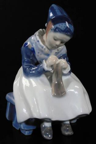 A 20thC Royal Copenhagen figure, of a girl darning, no. 13114, marked beneath, 18cm H.