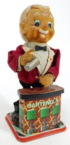 A mid 20thC Charlie Weaver Bartender mechanical toy, in typical standing pose, with a tin plate front in material jacket, 30cm H.