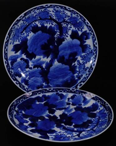 A matched pair of blue and white chargers, each of circular form, profusely decorated with flowers and an outer floral border, unmarked, 39cm Dia. (2)