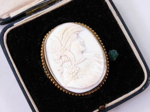 An early 20thC shell cameo brooch, of oval form, raised with a classical lady facing dexter, with a bead outline and plain pin back, 5cm H, in Mappin and Webb marked box.