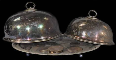 An early 20thC silver plated meat cover, by Walker and Hall, of domed form, with shaped handle, 40cm W, with associated stand, and another meat cover smaller. (a quantity)