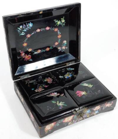 A Japanese Meiji period games box, of rectangular outline, lacquered with mother of pearl inlay, set with birds and flowers, the domed lid revealing four interior boxes containing a number of mother pearl and other gaming counters, faux half sovereign and